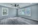 Light-filled bedroom with gray walls, ceiling fan, and wood-look floors at 7461 Church Hill Rd, Hollywood, SC 29449