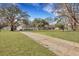 Long driveway leading to a home with a large backyard and garage at 7461 Church Hill Rd, Hollywood, SC 29449