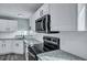 A close up of a kitchen featuring white cabinets, granite countertops, and stainless steel appliances at 7461 Church Hill Rd, Hollywood, SC 29449