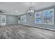 Open living room with hardwood floors and large windows, perfect for entertaining at 7461 Church Hill Rd, Hollywood, SC 29449