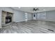 Bright living room with a stone fireplace, wood floors, and a welcoming atmosphere at 7461 Church Hill Rd, Hollywood, SC 29449