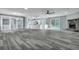 Spacious living room with wood floors, stone fireplace, and natural light at 7461 Church Hill Rd, Hollywood, SC 29449