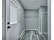 Mud room with door, shelving, and gray wood-look floors at 7461 Church Hill Rd, Hollywood, SC 29449