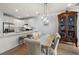 Dining area connecting to a modern kitchen with stainless steel appliances, white cabinets, and a spacious island at 801 Balgrove Ct # 801, Mount Pleasant, SC 29466