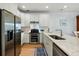Modern kitchen features stainless steel appliances, white cabinetry, marble countertops, and a stylish blue runner rug at 801 Balgrove Ct # 801, Mount Pleasant, SC 29466