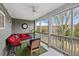 Relaxing screened porch with comfortable seating, ceiling fan and view of the wooded backyard at 801 Balgrove Ct # 801, Mount Pleasant, SC 29466