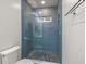 Modern walk-in shower with blue tile and mosaic floor, creating a spa-like experience at 801 Balgrove Ct # 801, Mount Pleasant, SC 29466