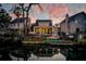 Waterfront home with a large backyard with a wooden deck overlooking the water at sunset at 810 Harbor Place Dr, Charleston, SC 29412