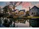 Waterfront home with a large backyard with a wooden deck overlooking the water at sunset at 810 Harbor Place Dr, Charleston, SC 29412