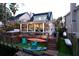 Stunning backyard featuring a wooden deck, lush green grass, outdoor furniture, and water access at 810 Harbor Place Dr, Charleston, SC 29412