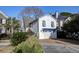 Charming home with mature landscaping, brick driveway, and white garage at 810 Harbor Place Dr, Charleston, SC 29412