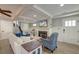 Cozy living room with a fireplace, hardwood floors, wainscoting, and comfortable seating at 810 Harbor Place Dr, Charleston, SC 29412