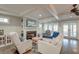 Cozy living room features a fireplace, white furniture, and plenty of natural light through multiple windows at 810 Harbor Place Dr, Charleston, SC 29412