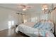 Bright bedroom with hardwood floors, barn door to en suite bath, and a coastal design at 810 Harbor Place Dr, Charleston, SC 29412