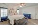 Light-filled main bedroom with hardwood floors, seating bench, and a charming accent wall at 810 Harbor Place Dr, Charleston, SC 29412
