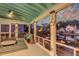 Relaxing screened porch overlooks the water, complete with comfortable seating and nautical decor for a serene retreat at 810 Harbor Place Dr, Charleston, SC 29412