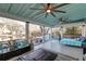 Spacious screened porch with waterfront view, ceiling fans, seating, and daybed at 810 Harbor Place Dr, Charleston, SC 29412