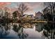 Scenic waterfront view showcases multiple homes, a calm lake, and a beautiful sunset creating a peaceful ambiance at 810 Harbor Place Dr, Charleston, SC 29412