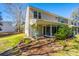 Serene backyard with a patio, lush lawn, and mature trees providing shade at 8120 Shadow Oak Dr, North Charleston, SC 29406