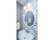 Modern bathroom featuring a round mirror, soft lighting, and decorative tile backsplash at 8120 Shadow Oak Dr, North Charleston, SC 29406