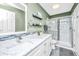 Bright bathroom featuring a vanity with marble countertops and glass enclosed shower at 8120 Shadow Oak Dr, North Charleston, SC 29406
