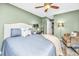 Comfortable bedroom with a ceiling fan, large bed, and cozy seating area at 8120 Shadow Oak Dr, North Charleston, SC 29406