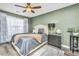 Comfortable bedroom with a ceiling fan, large bed and contemporary decor at 8120 Shadow Oak Dr, North Charleston, SC 29406