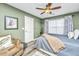 Comfortable bedroom with a ceiling fan, large bed, cozy seating area, and contemporary decor at 8120 Shadow Oak Dr, North Charleston, SC 29406