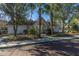 Community clubhouse surrounded by palm trees and well-maintained landscaping at 8120 Shadow Oak Dr, North Charleston, SC 29406