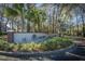 An entrance sign for Oak Bluff with manicured landscaping is surrounded by mature trees at 8120 Shadow Oak Dr, North Charleston, SC 29406