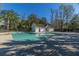 A community pool with clear, blue water and a building that likely houses restrooms and other amenities at 8120 Shadow Oak Dr, North Charleston, SC 29406