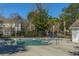 The community pool features clear blue water and is surrounded by trees and other natural landscaping at 8120 Shadow Oak Dr, North Charleston, SC 29406