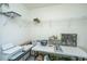 A hobby room that is brightly lit with shelving and a craft table at 8120 Shadow Oak Dr, North Charleston, SC 29406