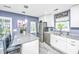 Well-lit kitchen featuring white cabinets, stainless steel appliances, and a granite island with seating at 8120 Shadow Oak Dr, North Charleston, SC 29406