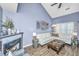 Living room displaying vaulted ceiling, fireplace, and contemporary decor against calming blue walls at 8120 Shadow Oak Dr, North Charleston, SC 29406