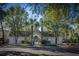 A community pool house features a gated entrance, surrounded by lush trees, in a quiet neighborhood at 8120 Shadow Oak Dr, North Charleston, SC 29406