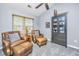 Relaxing sitting area with leather chairs, ottoman, and natural light at 8120 Shadow Oak Dr, North Charleston, SC 29406