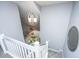 Bright foyer area with a white staircase and modern lighting at 8120 Shadow Oak Dr, North Charleston, SC 29406