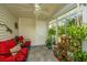 Cozy sunroom with comfortable seating, decorative plants, and ample natural light at 8120 Shadow Oak Dr, North Charleston, SC 29406