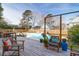 Charming backyard with a pool, wooden deck, lounge chairs and mature trees at 904 Watermelon Run, Charleston, SC 29412