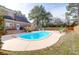 Spacious backyard with a pool, brick patio, mature trees, and lawn chairs at 904 Watermelon Run, Charleston, SC 29412