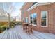 Backyard view from the deck showcasing brick home exterior, fenced yard and pool at 904 Watermelon Run, Charleston, SC 29412