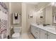 Updated bathroom features double vanity with white countertops, framed mirrors, and modern fixtures at 904 Watermelon Run, Charleston, SC 29412