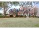Classic two-story brick home with a large front yard, mature trees, and a welcoming entrance at 904 Watermelon Run, Charleston, SC 29412