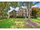 Charming two-story brick home with manicured lawn, mature trees, and inviting front entrance at 904 Watermelon Run, Charleston, SC 29412