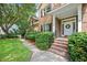 Inviting brick home entrance with a classic white door and well-manicured landscaping at 904 Watermelon Run, Charleston, SC 29412
