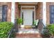 Charming front porch with brick accents and decorative chair at 904 Watermelon Run, Charleston, SC 29412