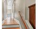 Upstairs hallway with hardwood floors and view into the living spaces from the stairwell at 904 Watermelon Run, Charleston, SC 29412