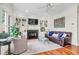 Comfortable living room with built-in shelving, a fireplace, hardwood floors, and ample natural light at 904 Watermelon Run, Charleston, SC 29412
