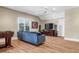 Spacious living room with hardwood floors, a blue velvet sofa, and a large window for natural light at 904 Watermelon Run, Charleston, SC 29412